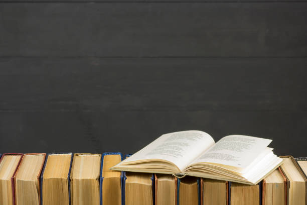 istock Open book, hardback books on wooden table. Back to school. Copy space 1182221550