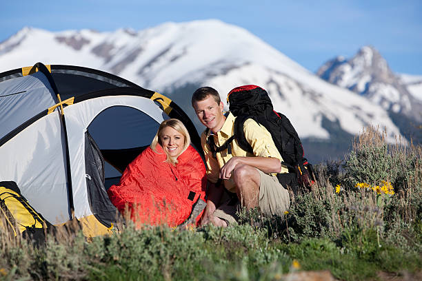 istock Couple Sitting In Front Of Tent Camping And Backpacking 118222464