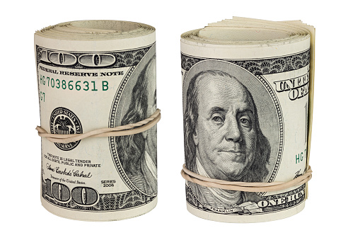 set of two rolls of hundred us dollars -50 pcs - standing up and isolated on white background.