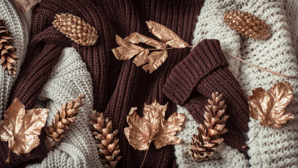 istock Autumn background with cozy sweaters and gold leaves . 1182226054