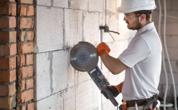istock The industrial Builder works with a professional angle grinder to cut bricks and build interior walls. Electrician. 1182226251