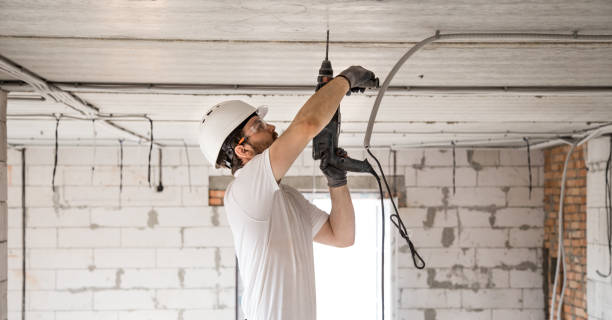 istock Handyman uses jackhammer, for installation, professional worker on the construction site. The concept of electrician and handyman. 1182226288