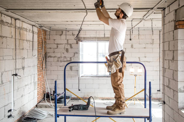 istock Electrician installer with a tool in his hands, working with cable on the construction site. 1182226297