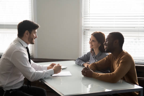Bank worker explaining contract details for clients.