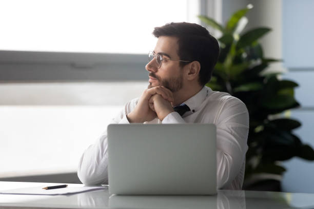 istock Distracted from job millennial businessman looking aside. 1182227825