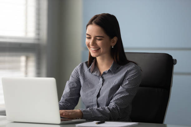 istock Happy millennial female employee manager working with computer at office. 1182227867