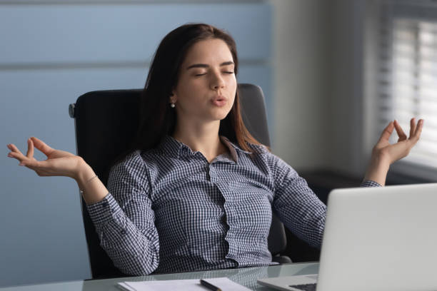 istock Young female worker making yoga breathing exercises. 1182227871
