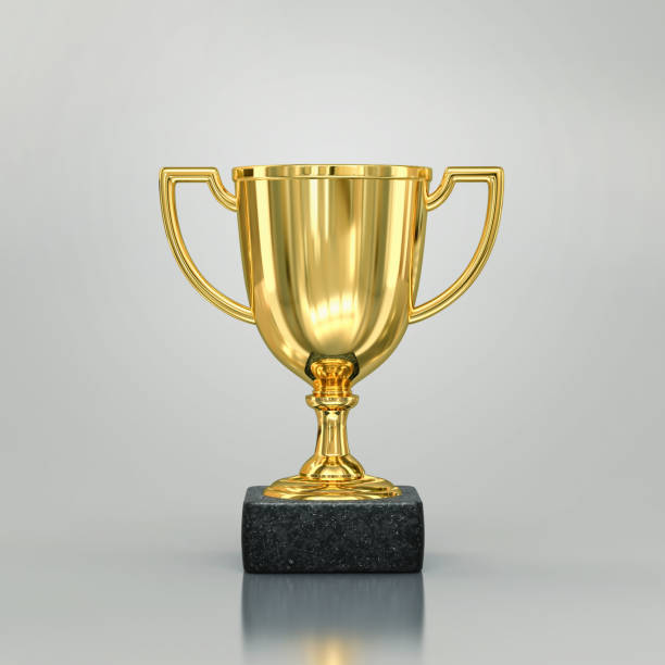 istock Golden champion cup with reflection on gray background 1182230389