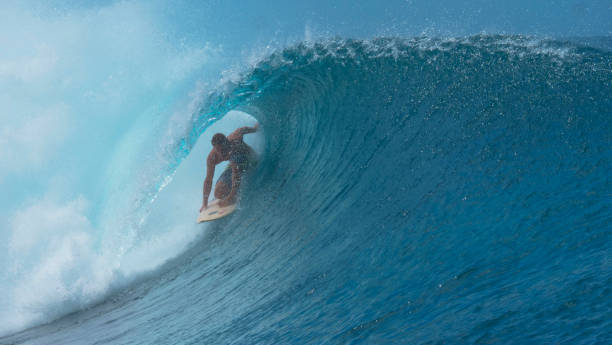 istock CLOSE UP: Stunning emerald water curls over surfer riding inside a barrel wave 1182230544