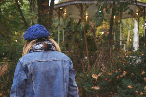 istock Woman standing in the park 1182230566