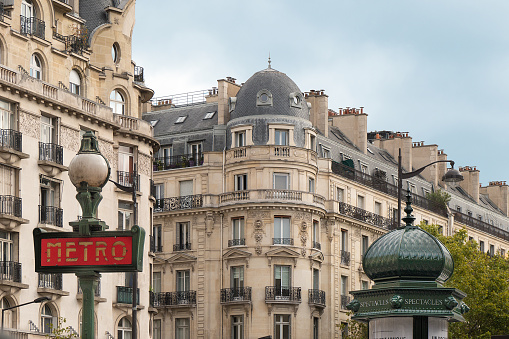 Paris, France. June 30 2022. Beautiful view of the houses of the historic center: charm and style of French architecture. On the right a street lamp.