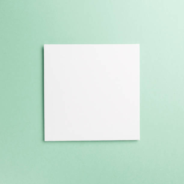 istock Creative layout made of paper blank on pastel on mint background. Top view. Flat lay. Copy space. Colorful background. Minimal creative concept. Neo mint - trendy color of the year 2020 1182233975