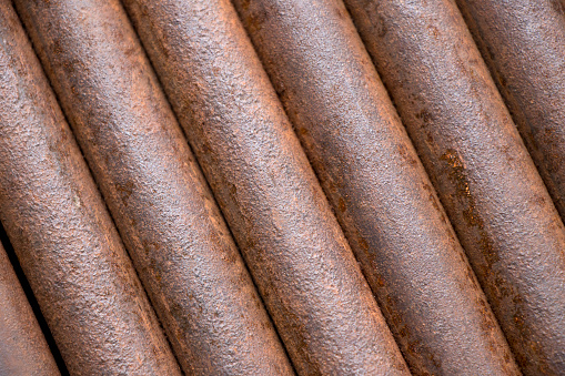 Detail of rusty iron tubes  on display