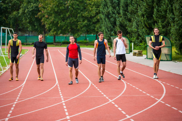 Back View of Young Athletic Man with Visual Impairment Practice Running with a Sighted Guide