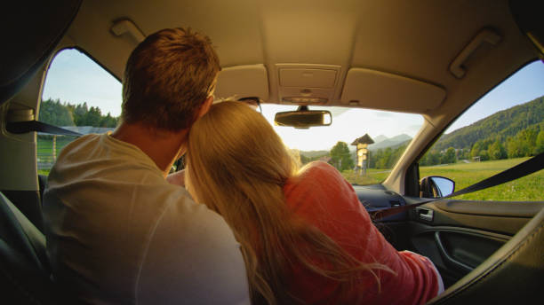 istock CLOSE UP: Unrecognizable couple cuddling while driving through the countryside. 1182246723