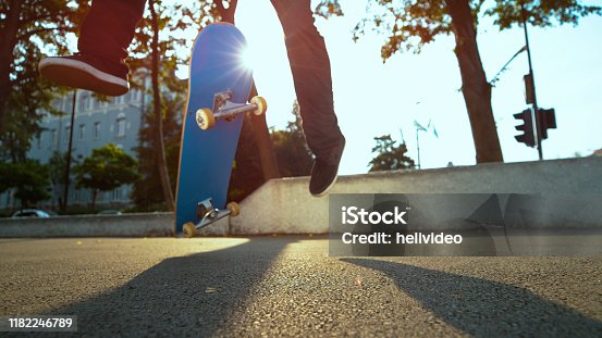 istock CLOSE UP: Unknown skateboarder jumps and lands a cool trick on concrete sidewalk 1182246789