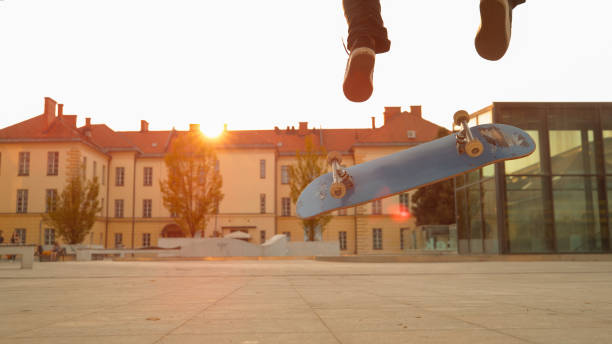 istock LENS FLARE: Unrecognizable athletic male does a flip trick on his skateboard. 1182247335