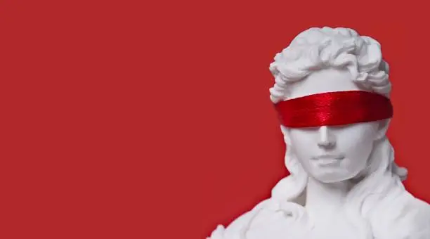 Close-up of lady justice with red blindfold. Panoramic image with copy space.
