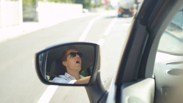 istock SLOW MOTION: Angry Caucasian man throwing a temper tantrum while driving to work 1182247494