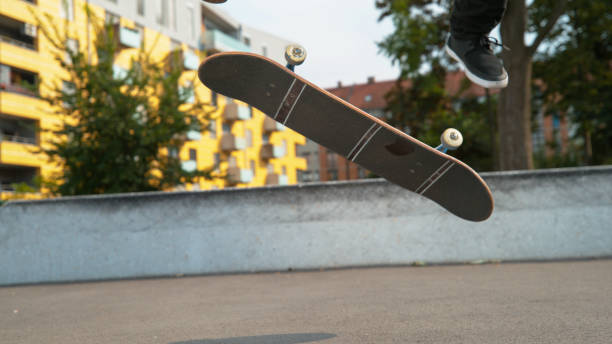 istock CLOSE UP: Unrecognizable male skateboarder does a varial kickflip in the park 1182247596