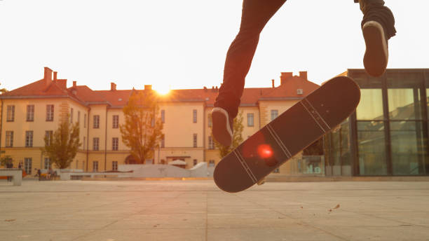 istock CLOSE UP: Young skater lands a cool trick while skating in urban park at sunset. 1182247703