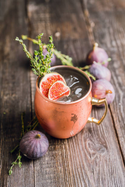 istock Moscow mule cocktail with figs and thyme on the rustic background 1182248054