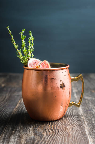 istock Moscow mule cocktail with figs and thyme on the rustic background 1182248056