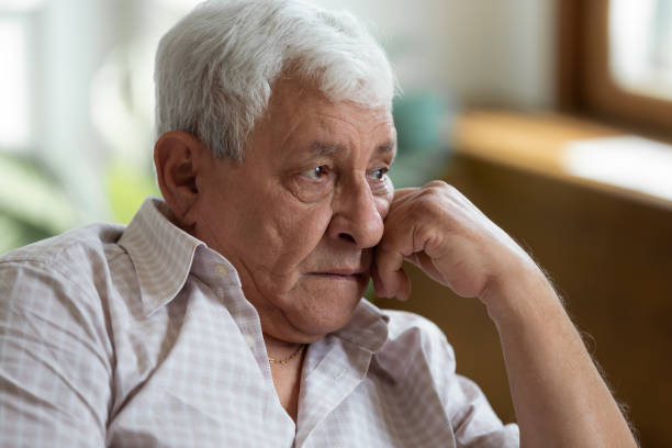istock Sad grandfather put head on hand lost in thoughts 1182248146