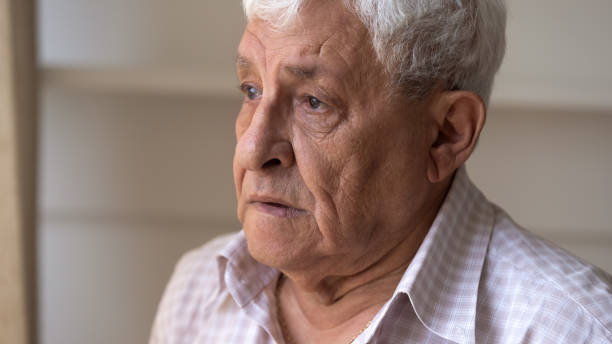 istock Close up face of sad senior man feels lonely 1182248155