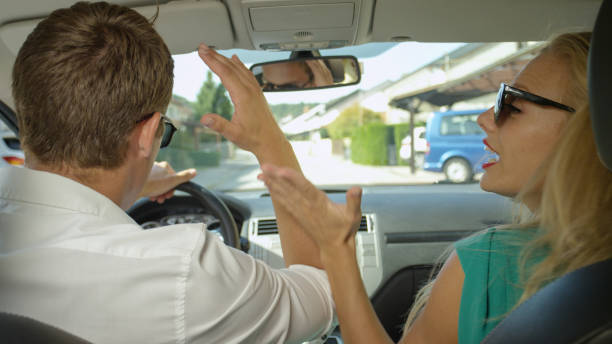 istock CLOSE UP: Furious man and woman argue while they drive through the suburbs. 1182248743