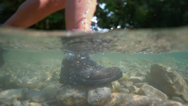 istock HALF UNDERWATER: Unrecognizable female hiker steps into the refreshing stream. 1182249311