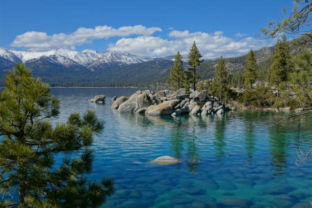 istock AERIAL: Flying over the breathtaking emerald lake under the snowy mountains. 1182250064