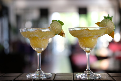 Two glass of margarita cocktails on bar counter