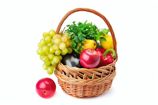 Vegetables and fruits in a basket isolated on white background. Healthy food.