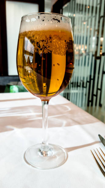 istock Beer poured into a glass is on the table with a white tablecloth in the restaurant 1182252147