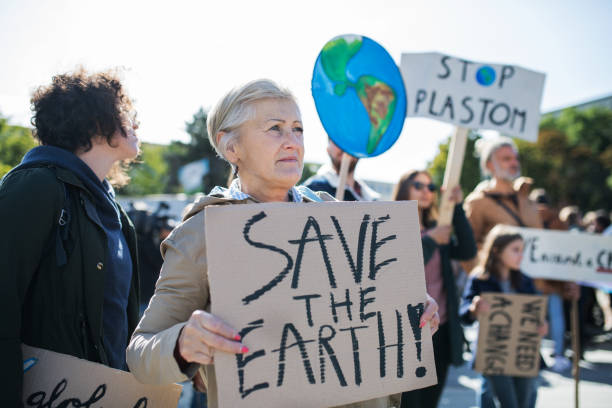 istock Senior with placard and poster on global strike for climate change. 1182252754