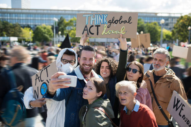 istock People with placards and posters on global strike for climate change, taking selfie. 1182252797