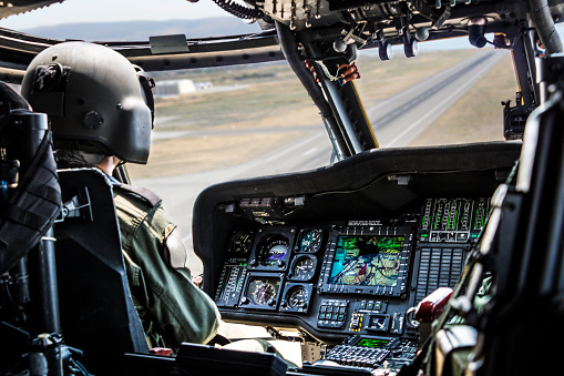 Helicopter Pilot riding military helicopter