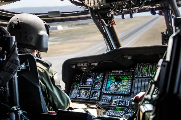 Photo of Army Helicopter Pilot riding military helicopter