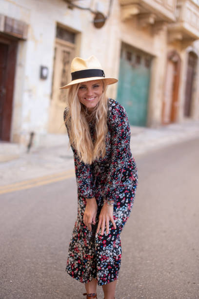 istock Blonde Mediterranean woman floral pattern dress posing at Valletta 1182257594