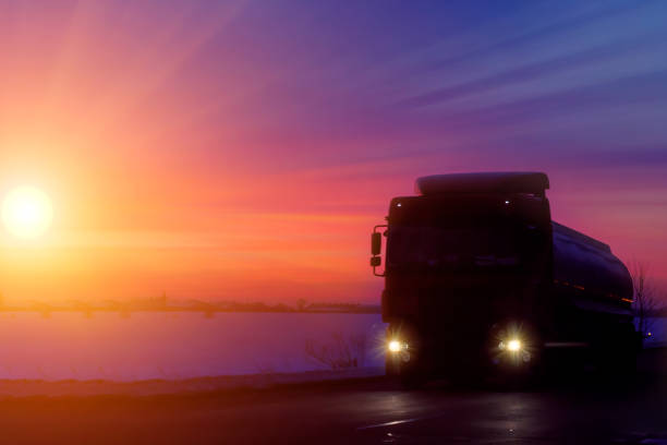 istock Silhouette Truck with container on highway, cargo transportation concept. Sunset background with copy space 1182261762