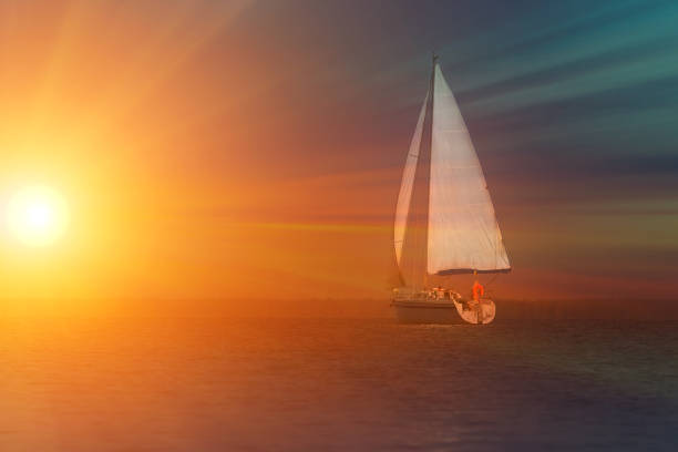 istock Sailing at sunset. A view from the yacht's deck to the bow and sails. Space for teht 1182261873
