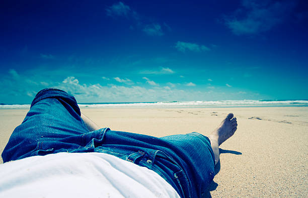 istock man relaxing on a deserted summer beach 118226366
