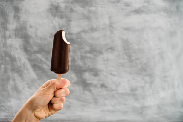istock Woman holding Eskimo pie in hand 1182265863