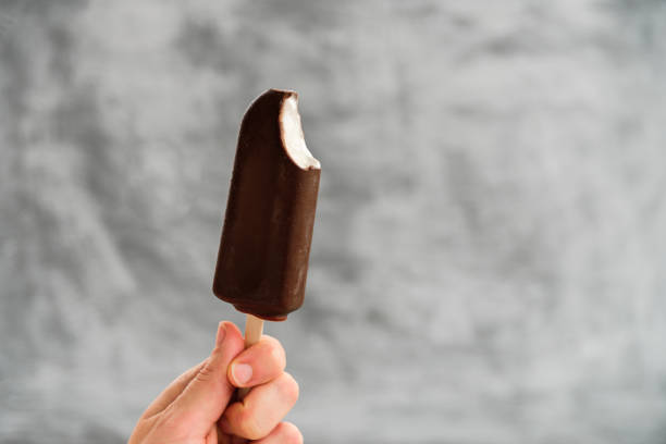 istock Woman holding Eskimo pie in hand 1182265940