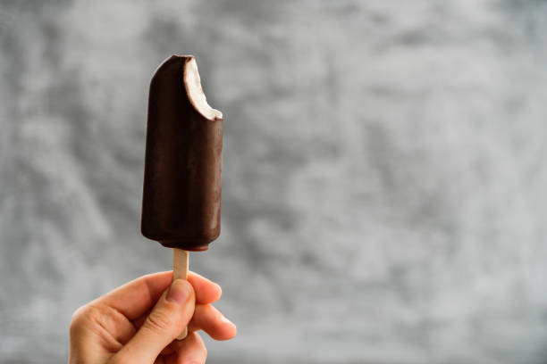 istock Woman holding Eskimo pie in hand 1182266118