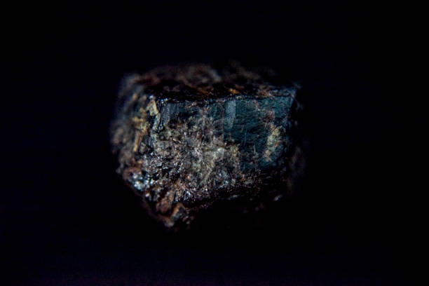 istock garnet stone hidden in rough form with metal ore 1182266181