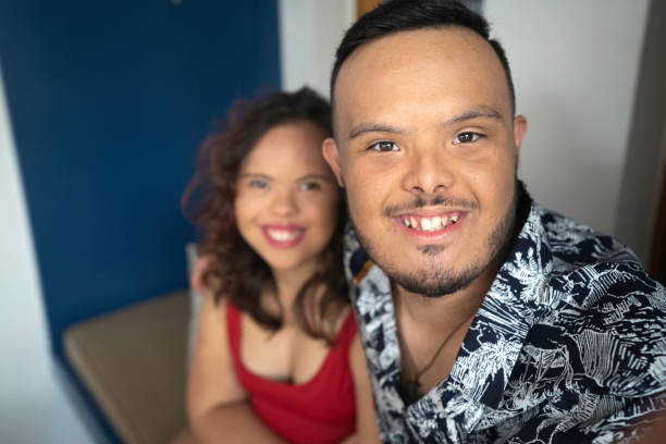 istock Smiling special needs couple taking a selfie 1182266915