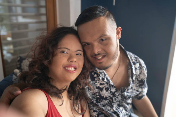 istock Smiling special needs couple taking a selfie 1182267870