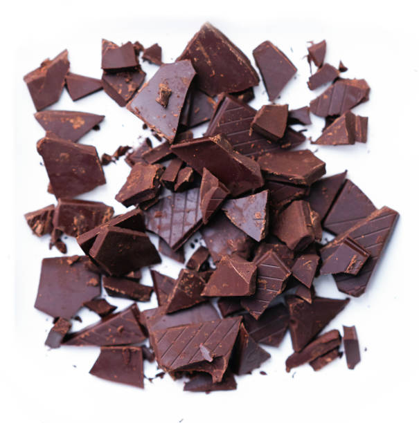 Chocolate bar in cracked pieces on white floor